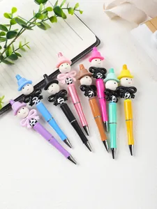 Assorted colorful cartoon beaded ballpoint pens with cute doll toppers and bow details.