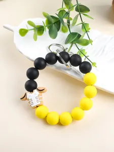 Detailed view of yellow and black silicone bead keychain with football jersey charm