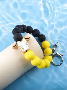 Detail showing football jersey charm on yellow and black silicone beaded wristlet keychain