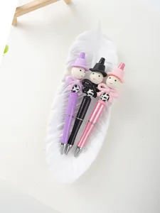 Detailed view of three cute cartoon beaded ballpoint pens in purple, black, and pink.