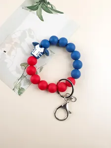 Detailed view of red and blue silicone beaded wristlet with football jersey charm