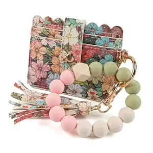 Porte-cartes élégant à imprimé floral avec bracelet en perles de silicone et porte-clés.