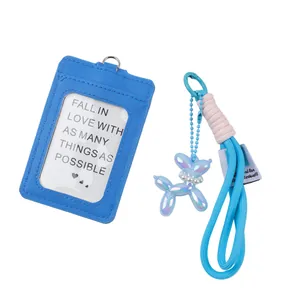 Detailed view of a blue ID card holder set with an iridescent balloon dog keychain
