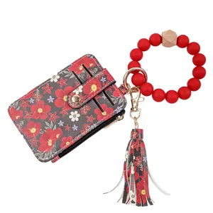 Floral print leather card holder with red silicone bead wristlet and tassel keychain