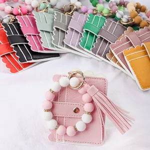 Colorful silicone beaded wristlet cardholders featuring elegant leather tassels and keychains