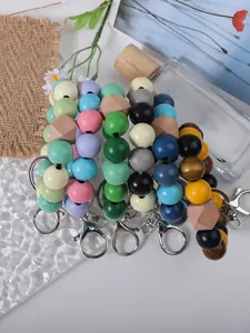 Close-up of colorful wooden bead bracelets with metal clasps on a stylish prop background