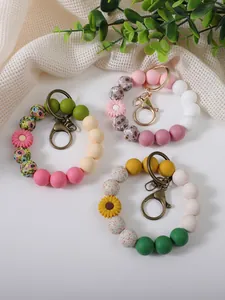 Detailed view of colorful silicone beaded wristlet keychains with cute floral daisy charms