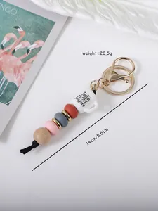 Detail of handmade keychain with coffee cup charm and colorful silicone beads