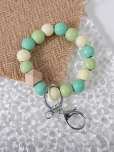 Detailed view of handmade colorful wooden bead bracelet keychain with rustic burlap