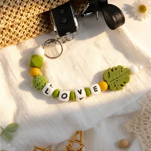 Detail van de handgemaakte siliconen kralen sleutelhanger met LOVE-letters en blad