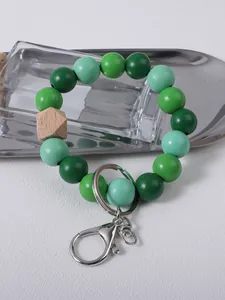 Detail view of green wooden beaded wristlet keychain with sturdy silver lobster clasp