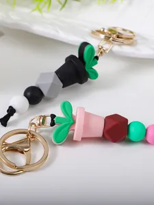 Detail showing colorful silicone beads and a cactus pot charm on a gold keychain