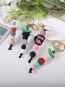 Close-up of silicone and wood bead keychains with coffee cup charms and lobster clasps