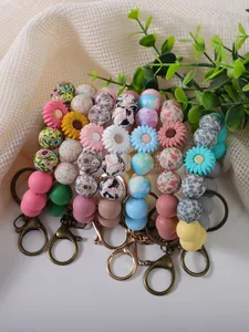 Close-up of colorful silicone bead keychains with daisy and floral prints
