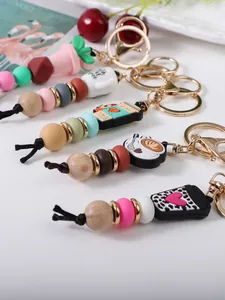 Close-up of assorted silicone and wooden beaded keychains with cute coffee charms
