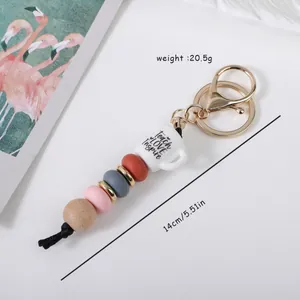 Silicone and wood bead keychain with 'Teach Love Inspire' coffee cup charm
