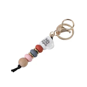 Silicone and wood bead keychain featuring a 'Teach LOVE Inspire' coffee cup charm