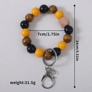Handmade wooden bead wristlet keychain with geometric accent and silver clasp