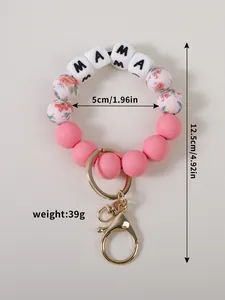 Détail du porte-clés en silicone rose avec perles MAMA et motifs floraux, poids 39g