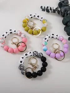 Variété de porte-clés en perles de silicone avec perles MAMA et motifs floraux élégants.
