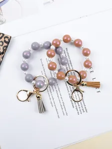 Detail view of silicone beaded keychain bracelets with decorative tassels
