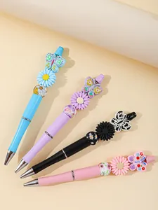 Detailed view of four colorful acrylic beaded pens with flower and butterfly charms