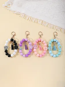 Colorful silicone bead wristlet keychains with decorative tassels and floral accents