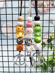 Detail of cute silicone beaded keychains featuring tiger, cat, and frog animal characters