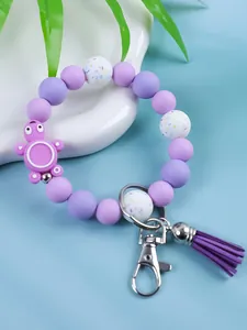 Detailed close-up of a cute purple silicone bead keychain with a turtle charm and tassel