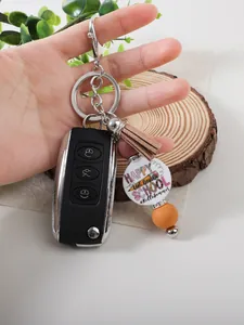 Handheld school themed silicone keychain with tassel and bead attached to car key