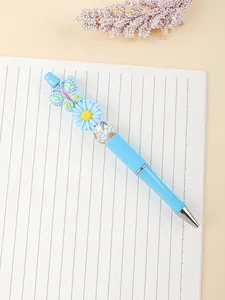 Detailed macro view of creative beaded pen with butterfly and daisy flower charms
