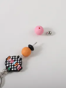 Close-up detail of DIY silicone bead keychain showing screw-off assembly components and beads
