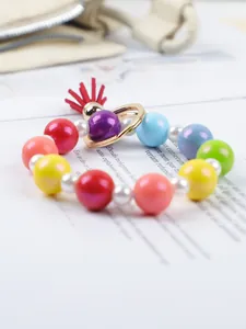 Macro view of a colorful macaron silicone beaded keychain featuring a vibrant red tassel