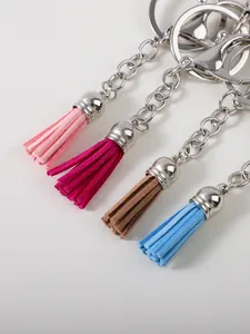 Close-up detail of colorful suede tassel keychains with polished silver metal rings and chains