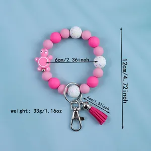 Pink silicone bead wristlet keychain with tassel and cute character charm