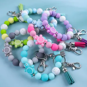 Collection of colorful silicone bead wristlet keychains with cute turtle charms and tassels