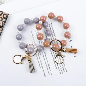Stylish silicone beaded wristlet keychain with macaron colors and suede tassel detail.