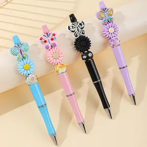 Set of four creative acrylic beaded ballpoint pens with butterfly and floral charm designs