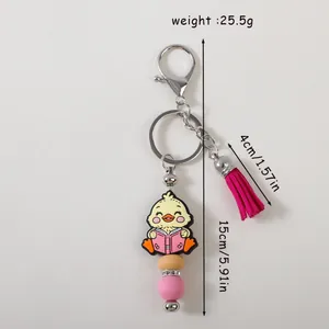 Cartoon chick silicone keychain with pink tassel and bead charms showing size and weight