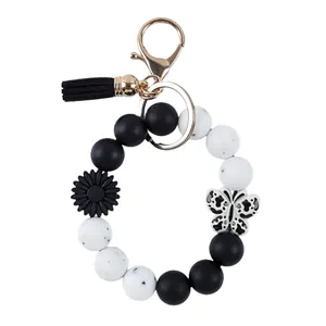 Black and white silicone beaded wristlet keychain with butterfly and flower charms