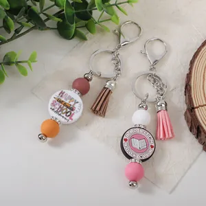 Handmade silicone beaded keychain with colorful tassels and school-themed charms