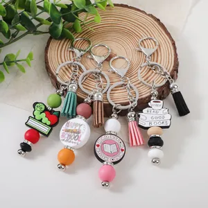 Colorful silicone beaded keychains with tassels and book-themed charms for school or gifts