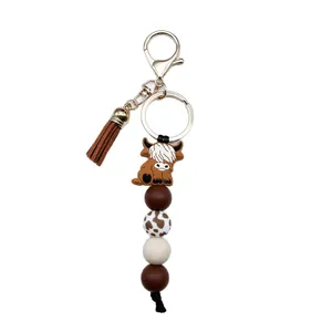 Llavero artesanal de cuentas de silicona de vaca Highland con borla marrón para bolso mujer