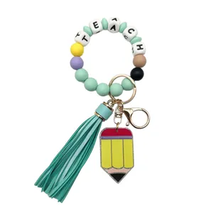 Llavero de pulsera de cuentas de silicona con letras TEACH, borla de colores y dije de lápiz.