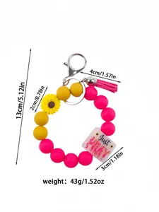 Detailed measurements and weight for the silicone bead wristlet keychain with pink tassel.