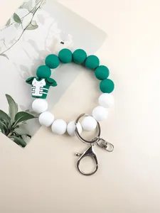 Detailed view of a green and white silicone bead keychain with an American football jersey charm