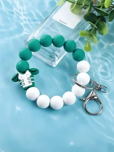 Detail view of green and white silicone beaded football jersey wristlet keychain