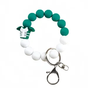 Silicone bead wristlet with green football jersey charm and silver metal keychain