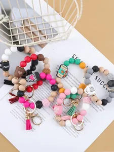 Detailed view of colorful silicone and wood bead bracelet keychains with cute charms