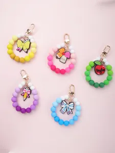 Collection of five colorful silicone beaded keychains with teacher-themed charms